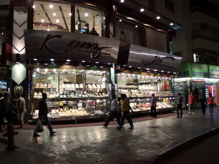 Jewellery shopfront glowing at night in the Dubai Gold Souk, Deira